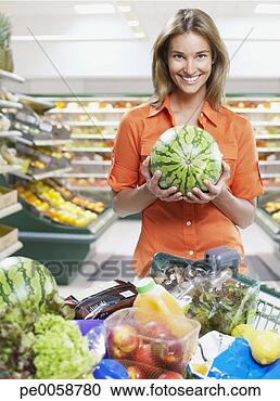 Stock Photography - woman holding 
watermelon while 
grocery shopping. 
fotosearch - search 
stock photos, 
pictures, images, 
and photo clipart