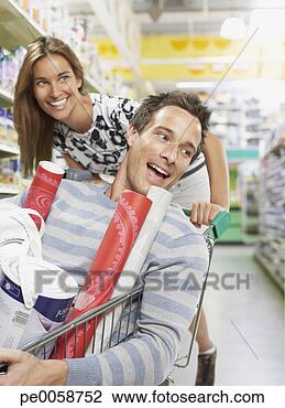 Stock Photo - woman pushing 
man in shopping 
cart. fotosearch 
- search stock 
photos, pictures, 
images, and photo 
clipart