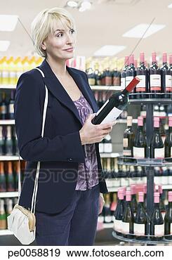 Stock Photograph - woman shopping 
for wine. fotosearch 
- search stock 
photos, pictures, 
images, and photo 
clipart