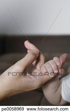 Stock Photograph - baby holding woman's 
finger in his 
hand. fotosearch 
- search stock 
photos, pictures, 
images, and photo 
clipart