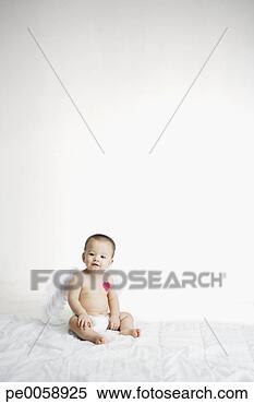 Stock Image - baby sitting with 
heart over his 
heart. fotosearch 
- search stock 
photos, pictures, 
images, and photo 
clipart