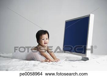Stock Photo - baby wearing tutu 
sitting in front 
of large computer. 
fotosearch - search 
stock photos, 
pictures, images, 
and photo clipart