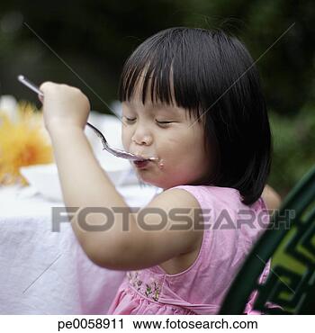 Stock Photography - girl eating outdoors. 
fotosearch - search 
stock photos, 
pictures, images, 
and photo clipart