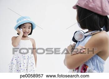 Picture - girl with headphones 
standing near 
girl with mobile 
phone. fotosearch 
- search stock 
photos, pictures, 
images, and photo 
clipart