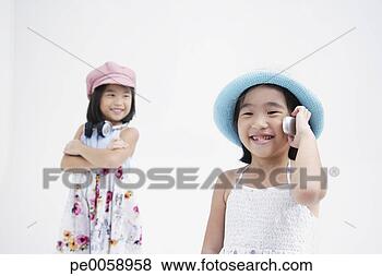 Stock Photo - girl with headphones 
standing near 
girl with mobile 
phone. fotosearch 
- search stock 
photos, pictures, 
images, and photo 
clipart