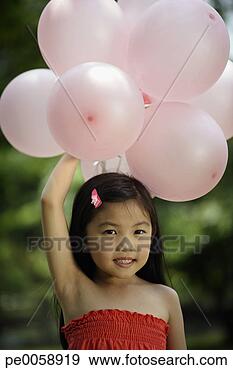Stock Photograph - girl holding balloons 
in air. fotosearch 
- search stock 
photos, pictures, 
images, and photo 
clipart