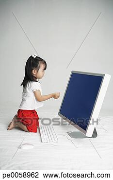 Stock Photo - girl sitting in 
front of large 
computer. fotosearch 
- search stock 
photos, pictures, 
images, and photo 
clipart