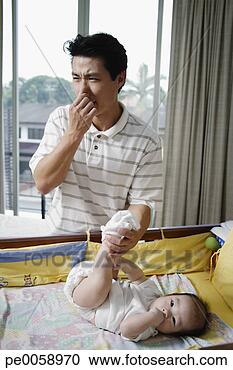 Stock Photography - man changing baby's 
diaper. fotosearch 
- search stock 
photos, pictures, 
images, and photo 
clipart
