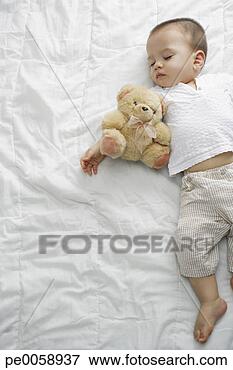 Picture - sleeping boy with 
teddy bear on 
bed. fotosearch 
- search stock 
photos, pictures, 
images, and photo 
clipart