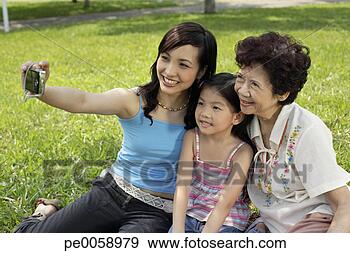 Stock Photograph - three generations 
of women in park 
taking picture. 
fotosearch - search 
stock photos, 
pictures, images, 
and photo clipart