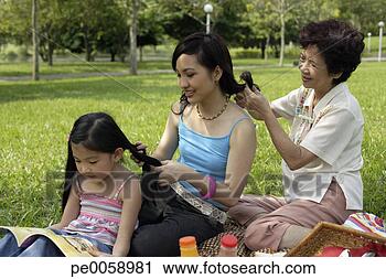 Stock Photography - three generations 
of women in park 
braiding each 
other's hair. 
fotosearch - search 
stock photos, 
pictures, images, 
and photo clipart