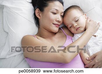 Stock Photograph - woman with baby 
sleeping in bed. 
fotosearch - search 
stock photos, 
pictures, images, 
and photo clipart