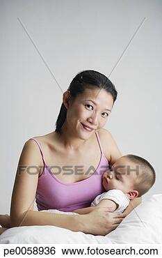 Stock Photo - woman holding 
sleeping baby. 
fotosearch - search 
stock photos, 
pictures, images, 
and photo clipart