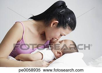 Stock Image - woman snuggling 
with baby. fotosearch 
- search stock 
photos, pictures, 
images, and photo 
clipart