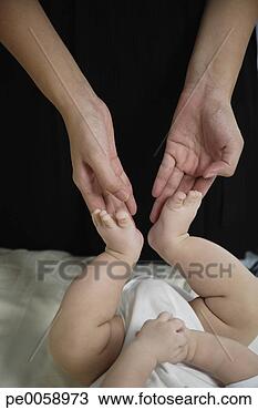 Stock Photo - woman touching 
baby's feet. fotosearch 
- search stock 
photos, pictures, 
images, and photo 
clipart