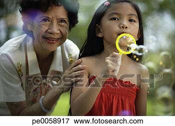 Picture - woman and young 
girl blowing bubbles. 
fotosearch - search 
stock photos, 
pictures, images, 
and photo clipart