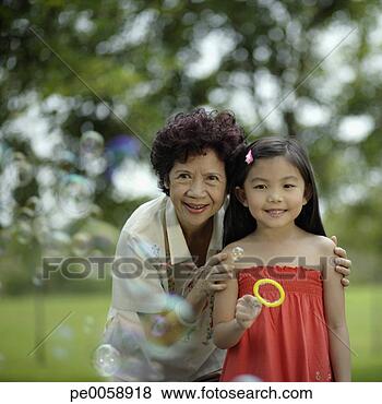 Stock Photo - woman and young 
girl blowing bubbles. 
fotosearch - search 
stock photos, 
pictures, images, 
and photo clipart