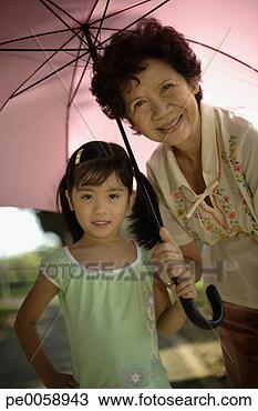 Stock Photo - woman and young 
girl holding umbrella 
outdoors. fotosearch 
- search stock 
photos, pictures, 
images, and photo 
clipart