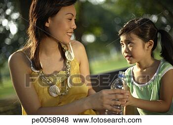Stock Photo - woman and young 
girl sharing bottle 
of water. fotosearch 
- search stock 
photos, pictures, 
images, and photo 
clipart