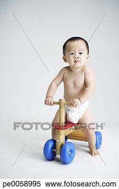 Stock Image - baby on toy bike. 
fotosearch - search 
stock photos, 
pictures, images, 
and photo clipart