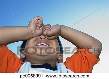 Stock Photography - boy with hands 
over eyes outdoors. 
fotosearch - search 
stock photos, 
pictures, images, 
and photo clipart