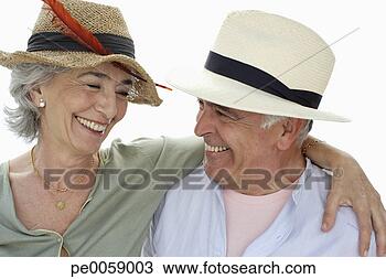 Stock Photo - couple wearing 
hats smiling at 
each other. fotosearch 
- search stock 
photos, pictures, 
images, and photo 
clipart