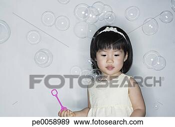 Stock Photograph - girl blowing bubbles. 
fotosearch - search 
stock photos, 
pictures, images, 
and photo clipart