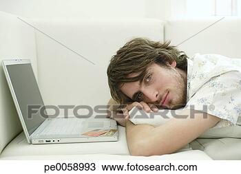 Stock Photo - man relaxing on 
sofa with laptop. 
fotosearch - search 
stock photos, 
pictures, images, 
and photo clipart