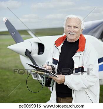 Stock Image - man standing by 
a small airplane. 
fotosearch - search 
stock photos, 
pictures, images, 
and photo clipart