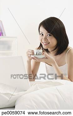 Stock Photo - woman drinking 
cup of tea. fotosearch 
- search stock 
photos, pictures, 
images, and photo 
clipart
