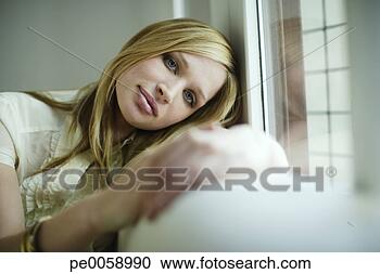 Stock Photography - woman relaxing 
indoors. fotosearch 
- search stock 
photos, pictures, 
images, and photo 
clipart