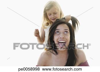 Stock Photo - young girl playing 
with woman's hair. 
fotosearch - search 
stock photos, 
pictures, images, 
and photo clipart
