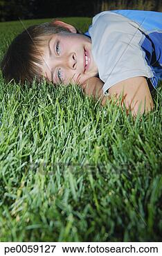 Picture - boy lying in grass. 
fotosearch - search 
stock photos, 
pictures, images, 
and photo clipart