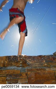 Stock Photo - boy's legs kicking 
water on stone 
wall. fotosearch 
- search stock 
photos, pictures, 
images, and photo 
clipart