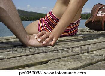 Stock Photo - couple holding 
hands on dock. 
fotosearch - search 
stock photos, 
pictures, images, 
and photo clipart