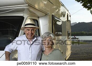 Stock Photography - couple leaning 
against recreational 
vehicle. fotosearch 
- search stock 
photos, pictures, 
images, and photo 
clipart