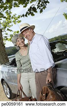 Stock Photography - couple standing 
by convertible 
car with bags. 
fotosearch - search 
stock photos, 
pictures, images, 
and photo clipart