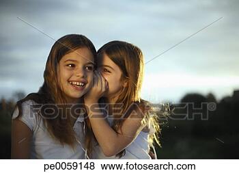 Stock Photo - girl whispering 
in other girl's 
ear. fotosearch 
- search stock 
photos, pictures, 
images, and photo 
clipart