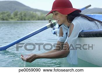 Stock Photography - woman in boat 
with hands in 
water. fotosearch 
- search stock 
photos, pictures, 
images, and photo 
clipart