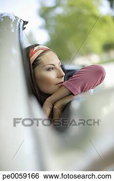 Stock Photo - woman in a convertible 
car leaning on 
window. fotosearch 
- search stock 
photos, pictures, 
images, and photo 
clipart