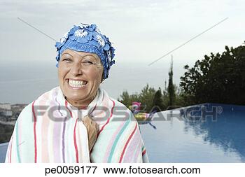 Picture - woman on deck 
by infinity pool. 
fotosearch - search 
stock photos, 
pictures, images, 
and photo clipart