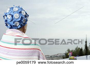 Stock Photograph - woman on deck 
by infinity pool. 
fotosearch - search 
stock photos, 
pictures, images, 
and photo clipart