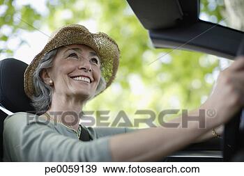 Stock Photograph - woman driving 
convertible car 
wearing hat. fotosearch 
- search stock 
photos, pictures, 
images, and photo 
clipart