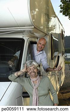 Stock Photography - woman leaning 
against recreational 
vehicle with man 
inside. fotosearch 
- search stock 
photos, pictures, 
images, and photo 
clipart