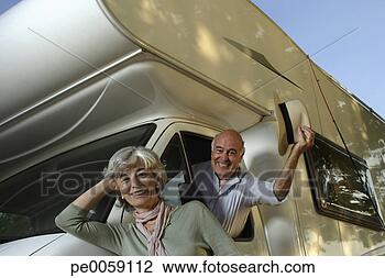 Stock Photo - woman leaning 
against recreational 
vehicle with man 
inside. fotosearch 
- search stock 
photos, pictures, 
images, and photo 
clipart