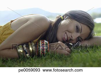 Stock Photo - woman lying in 
grass. fotosearch 
- search stock 
photos, pictures, 
images, and photo 
clipart