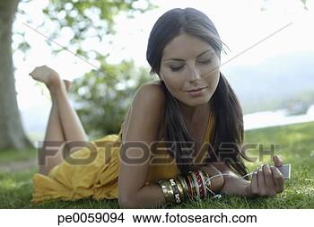 Stock Photo - woman with mp3 
player outdoors. 
fotosearch - search 
stock photos, 
pictures, images, 
and photo clipart