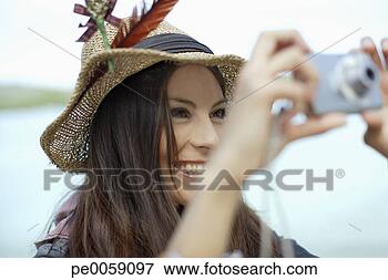 Picture - woman using camera 
outdoors. fotosearch 
- search stock 
photos, pictures, 
images, and photo 
clipart