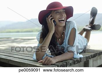 Stock Photography - woman using her 
mobile phone on 
dock. fotosearch 
- search stock 
photos, pictures, 
images, and photo 
clipart