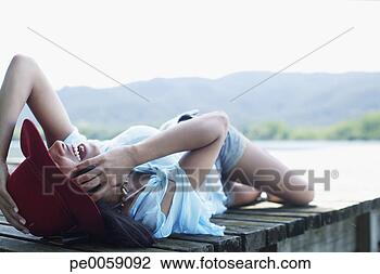 Stock Photo - woman using her 
mobile phone on 
dock. fotosearch 
- search stock 
photos, pictures, 
images, and photo 
clipart